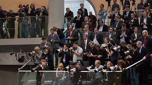 Journalists throng the press gallery in the German Bundestag.