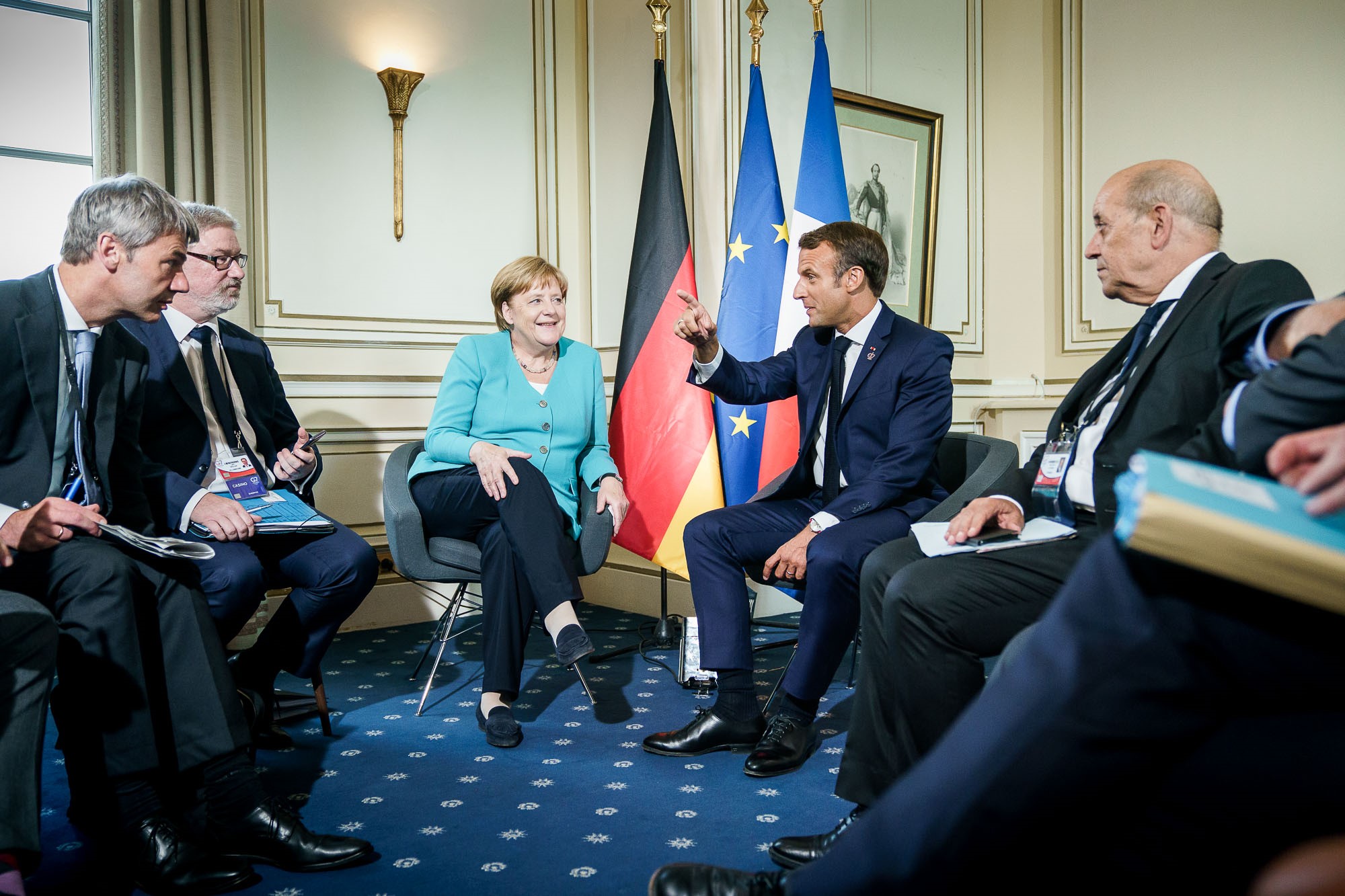Chancellor Angela Merkel in discussion with French President Emmanuel Macron at the G7 summit in Biarritz