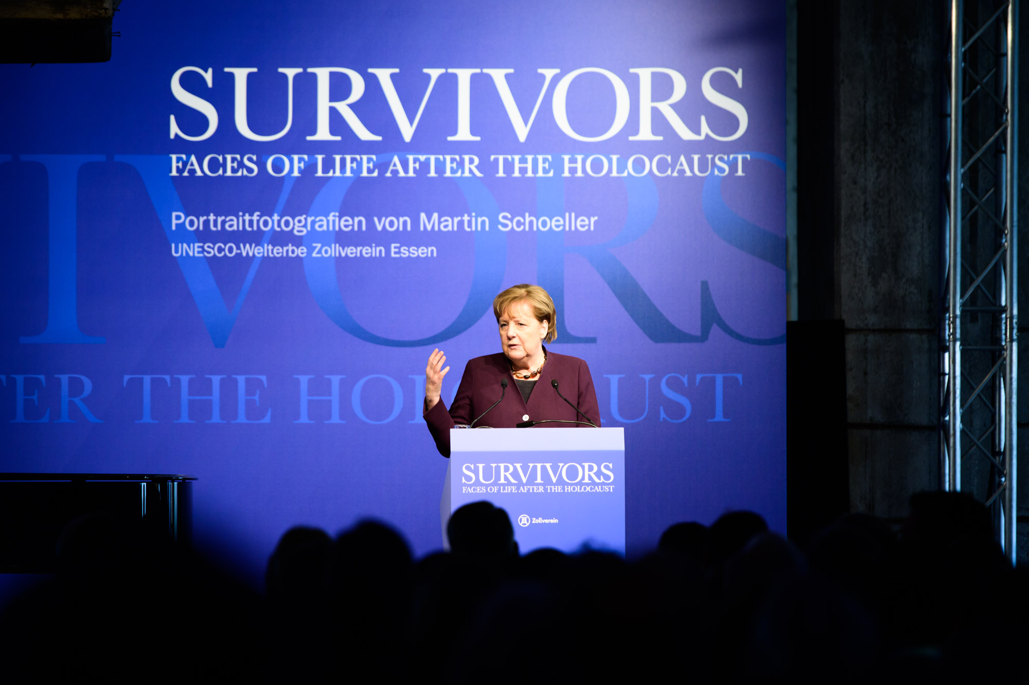 Chancellor Angela Merkel speaks at the opening of the "Survivors" exhibition.