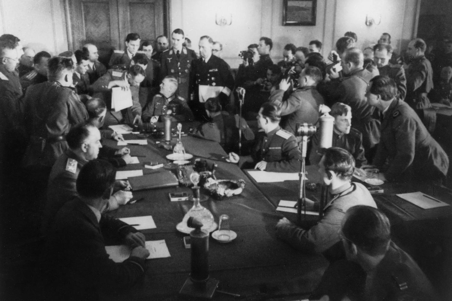 Wehrmacht representatives sign the unconditional surrender.