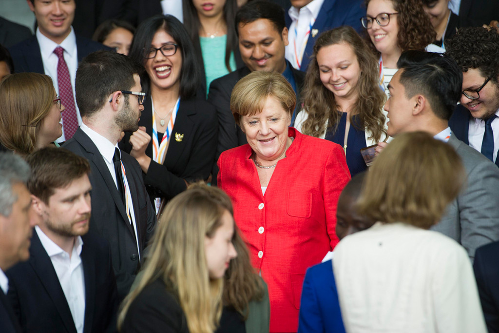 Chancellor Angela Merkel and participants at the Y20 summit gather for a group photo at the Federal Chancellery.