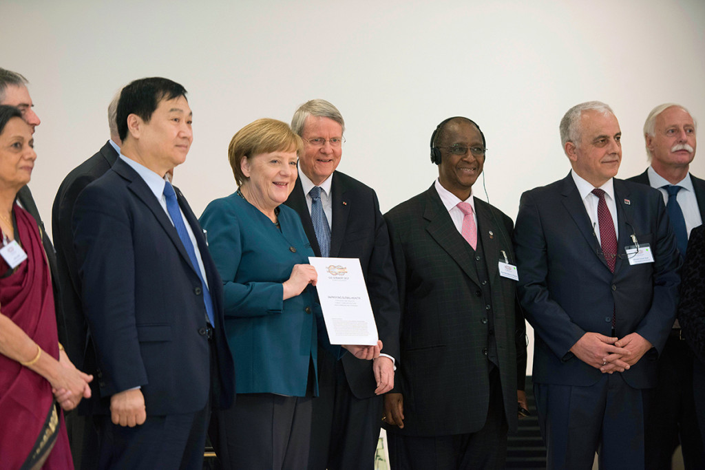 Leading G20 scientists present Chancellor Angela Merkel with a communiqué on imrpoving health care during the Science20 summit at the Leopoldina, the German National Academy of Sciences, in Halle.