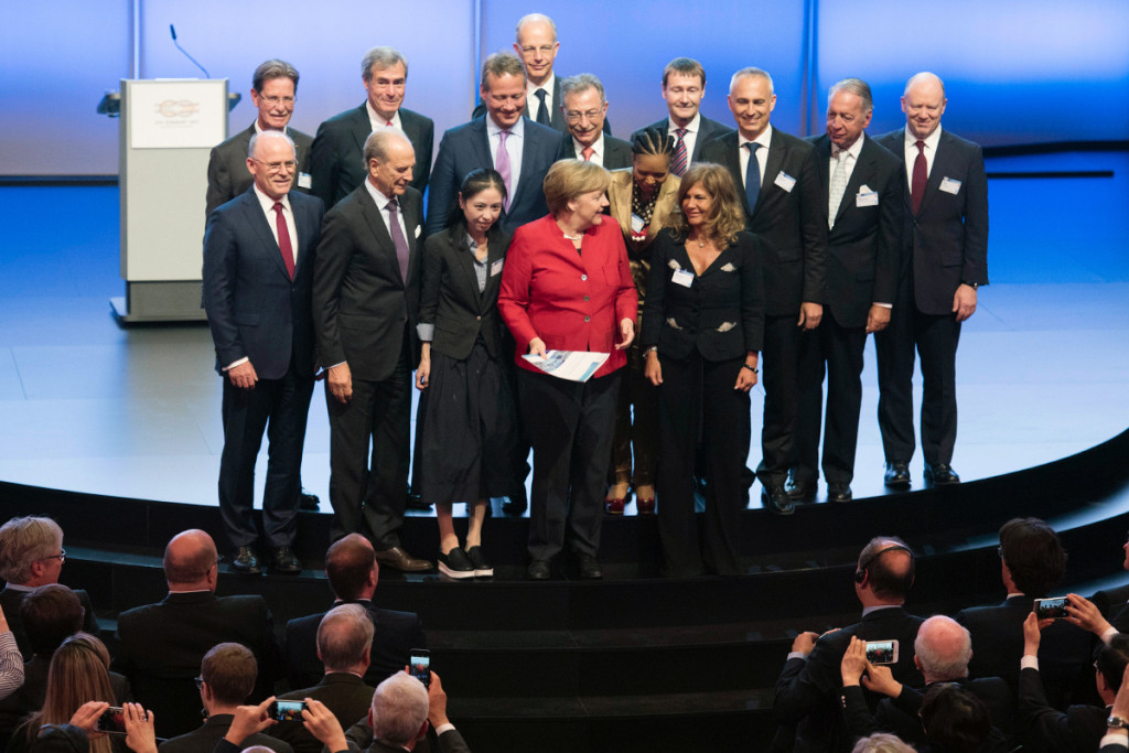 Chancellor Angela Merkel (centre) with the recommendations and proposals for action drawn up by leading business representatives at the Business20 summit