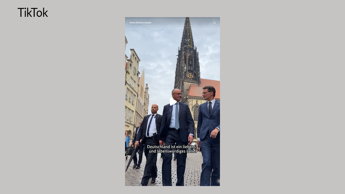 Das Foto zeigt Kanzler Merz mit dem Ministerpräsidenten von Nordrhein-Westfalen, Hendrik Wüst, beim Antrittsbesuch des Kanzlers im Bundesland. Dazu der Text: Deutschland ist ein liebens- und lebenswürdiges Land.