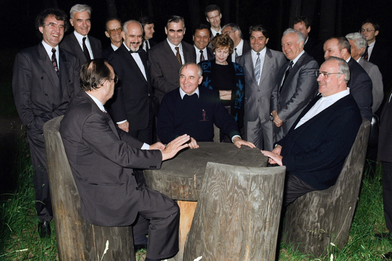 Bundeskanzler Helmut Kohl im Gespräch mit dem sowjetischen Michail Gorbatschow und Außenminister Hans-Dietrich Genscher an einem Holztisch über die volle Souveränität des vereinten Deutschlands.