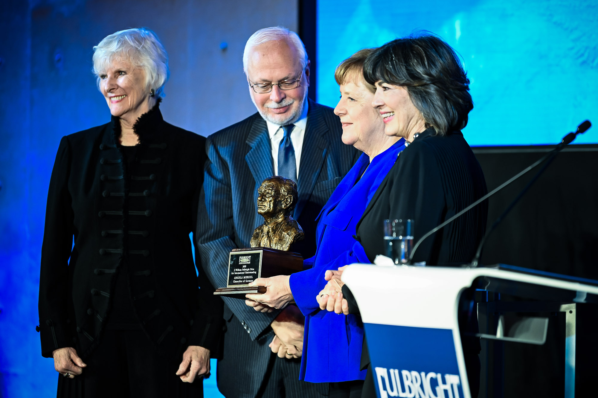 Chancellor Merkel holds the award in her hand 