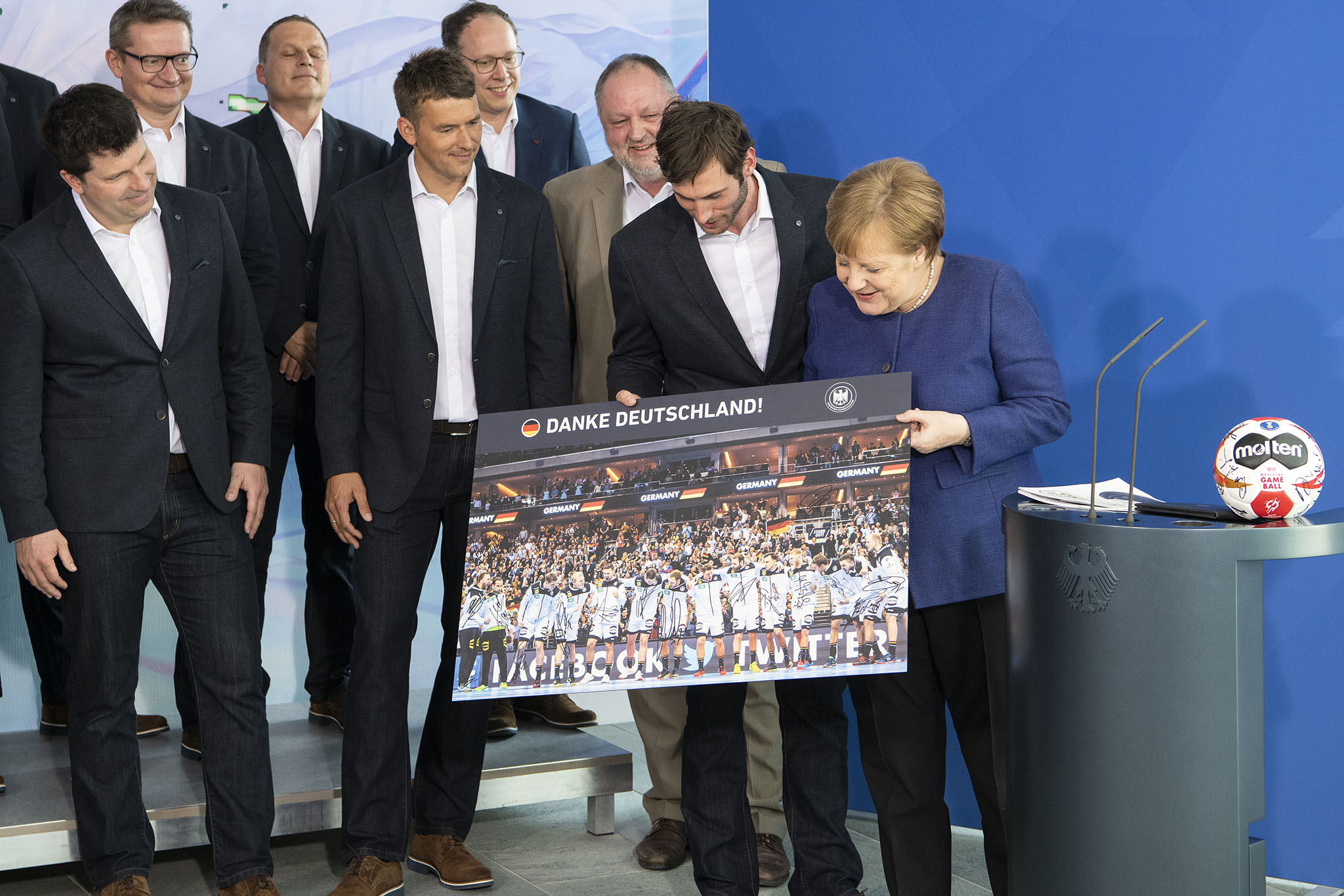 Chancellor Angela Merkel with some of the German national handball squad at the Federal Chancellery