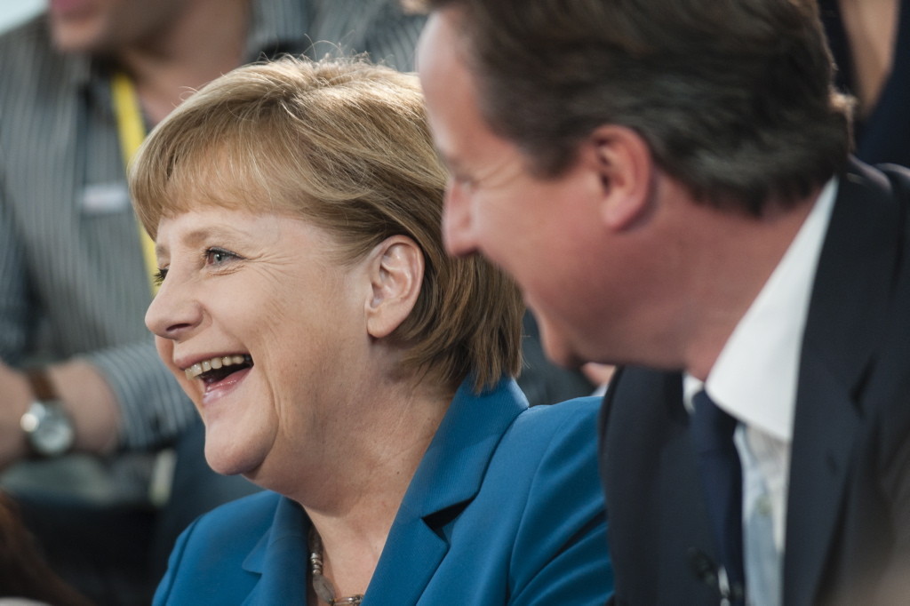 Chancellor Angela Merkel and David Cameron laugh during the discussion.