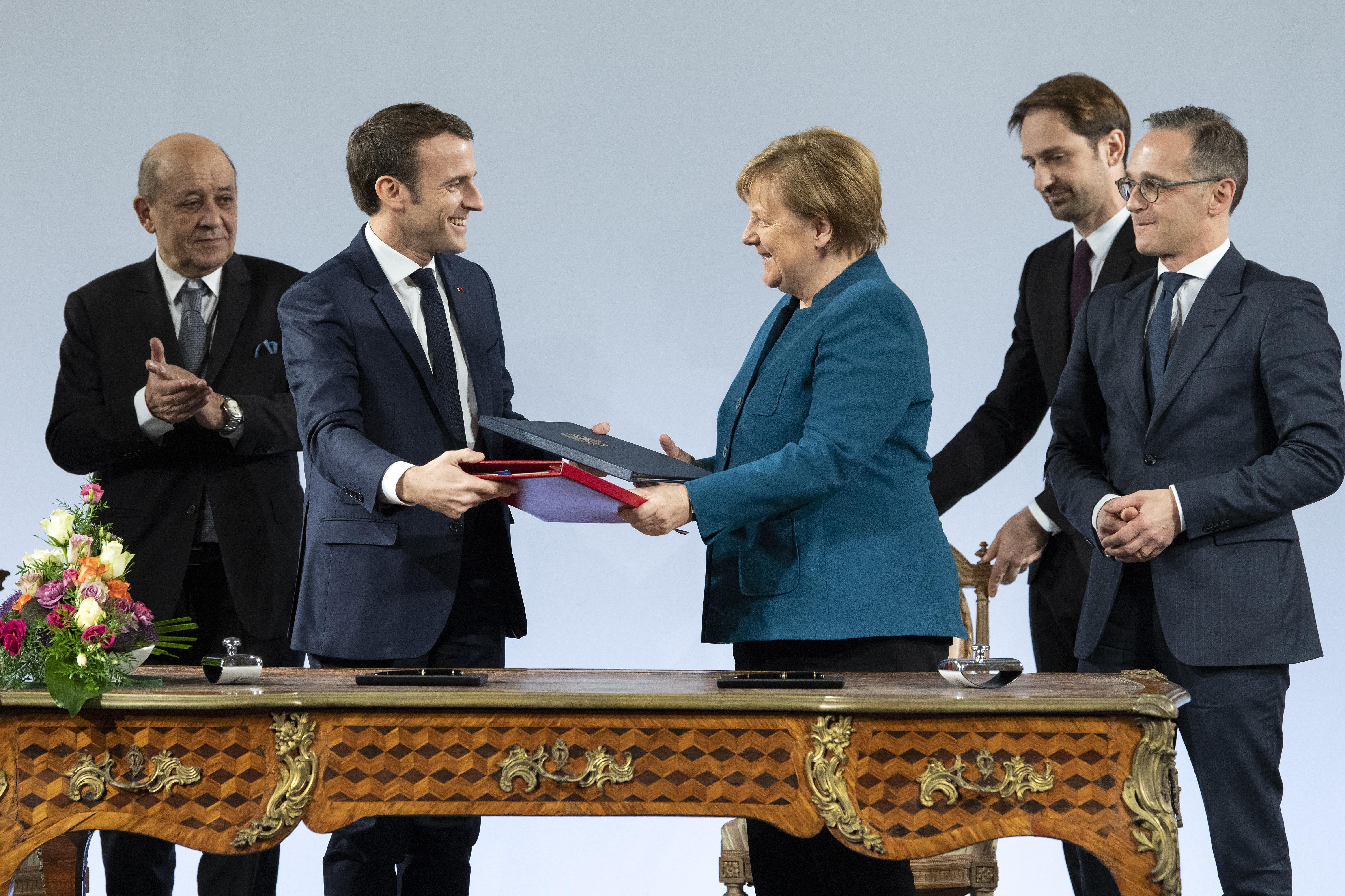 Chancellor Angela Merkel and French President Emmanuel Macron at the signing ceremony