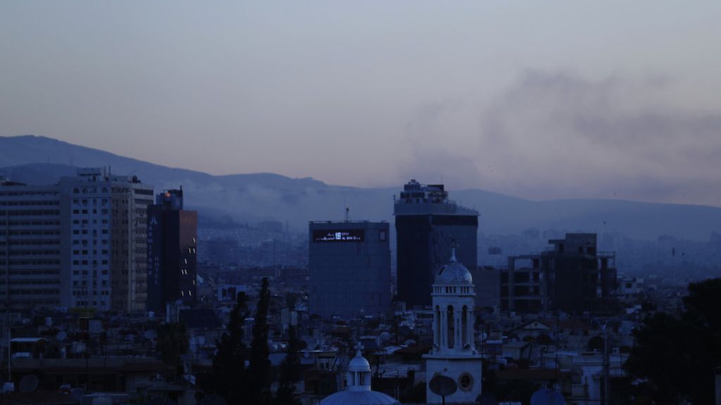 Smoke rises after airstrikes targeting different parts of the Syrian capital Damascus, Syria, early Saturday, April 14, 2018. (AP Photo/Hassan Ammar) |