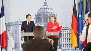 Chancellor Angela Merkel and French President Emmanuel Macron give a joint press conference.