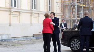 Chancellor Angela Merkel welcomes French President Emmanuel Macron.