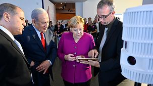 Chancellor Angela Merkel and Israel's Prime Minister Benjamin Netanyahu at an information stand