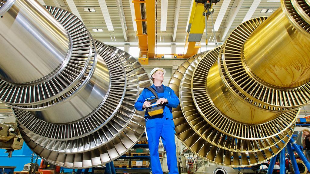 Ein Mitarbeiter der Turbinenfertigung in einer Fabrikhalle 