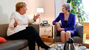 Chancellor Angela Merkel in discussion with British Prime Minister Theresa May on the sidelines of a European Council meeting.