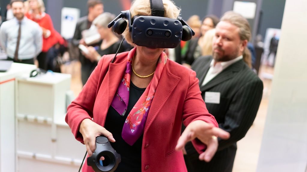 Kulturstaatsministerin Grütters trägt eine Virtual-Reality-Brille.