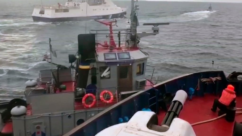 This image taken from a video of the Russian intelligence service shows a Russian coastguard vessel and a Ukrainian tug in the Strait of Kerch.