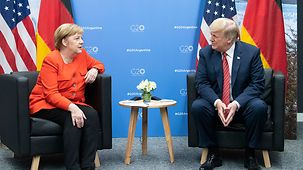 Angela Merkel in discussion with Donald Trump