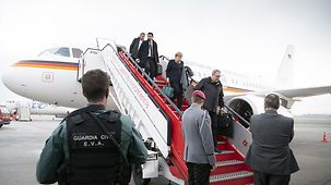 Chancellor Angela Merkel alights from the aeroplane.