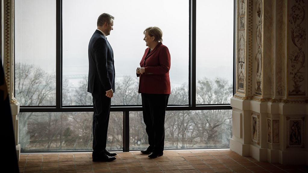 Chancellor Angela Merkel in conversation with Slovak Prime Minister Peter Pellegrini