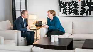 Chancellor Angela Merkel in conversation with Donald Tusk, President of the European Council