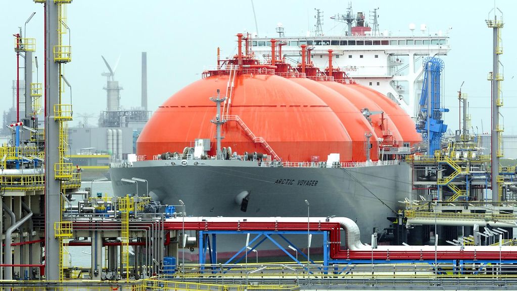 Zu sehen ist ein Schiff mit riesigen orangefarbigen Kuppeln im Hafen von Rotterdam.