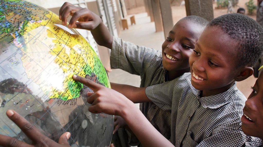 Schoolchildren with globe in Ouagadougou, Burkina Faso