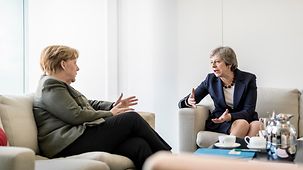 Chancellor Angela Merkel in conversation with British Prime Minister Theresa May