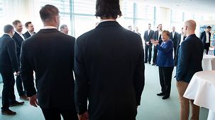 Chancellor Angela Merkel receives Germany's national handball team.