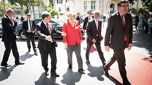 Chancellor Angela Merkel is welcomed on her arrival at the "Haus der Geschichte", a contemporary history collection.