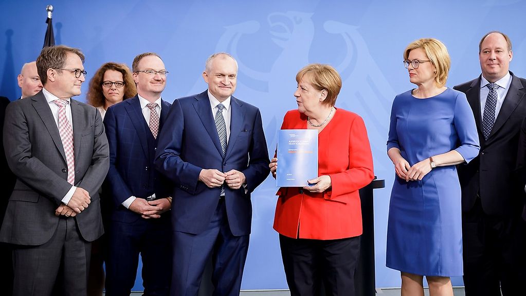 Mitglieder des Sachverständigenrats für Wirtschaftsfragen übergeben Angela Merkel das Gutchten. Bundeslandwirtschaftsministerin Julia Klöckner und Bundeskanzleramtschef Helge Braun stehen neben der Kanzlerin.