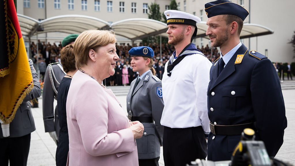 Nach Abschluss des feierlichen Gelöbnisses spricht die Kanzlerin mit Rekruten der Bundeswehr.