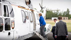 Chancellor Angela Merkel ascends the steps to the helicopter that is to take her to Dresden.