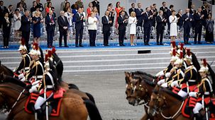 Chancellor Angela Merkel and other European leaders watch the military parade in Paris to mark the "Bastille Day" celebrations.