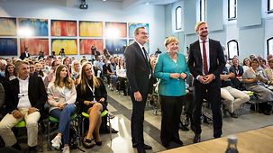 Chancellor Angela Merkel with Andreas Ebel, editor in chief of the newspaper Ostsee-Zeitung, and Gordon Repinski, head of the Berlin office and deputy editor of RedaktionsNetzwerk Deutschland.