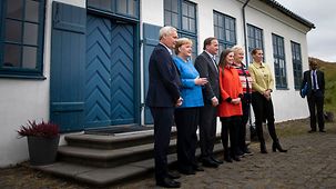 Chancellor Angela Merkel in front of the Videy House