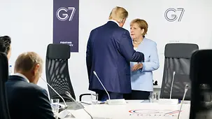 Chancellor Angela Merkel in discussion with President Donald Trump during the G7 summit in Biarritz