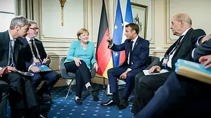 Chancellor Angela Merkel in discussion with French President Emmanuel Macron at the G7 summit in Biarritz
