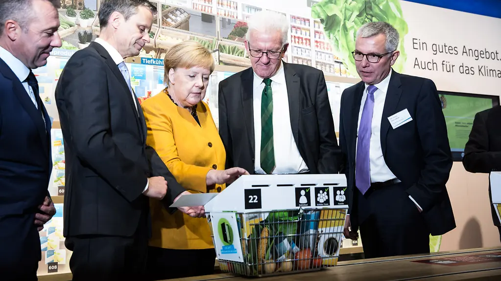 Chancellor Angela Merkel during a tour of the Klima-Arena, which she officially opened
