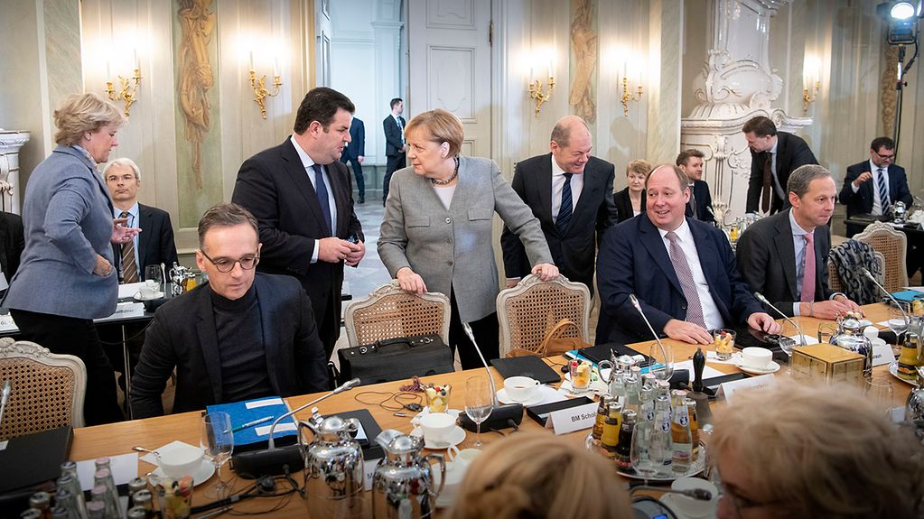 Chancellor Angela Merkel talks with Hubertus Heil, Federal Minister of Labour and Social Affairs, during the Cabinet retreat at Schloss Meseberg