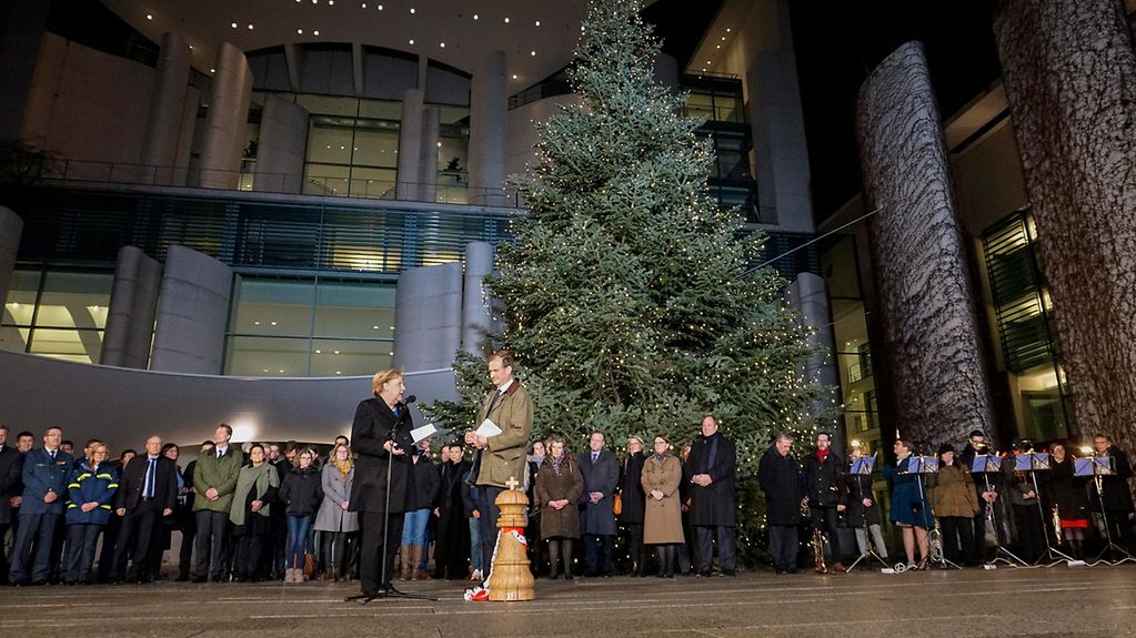 Chancellor Angela Merkel is presented with the traditional Christmas trees at the Federal Chancellery.