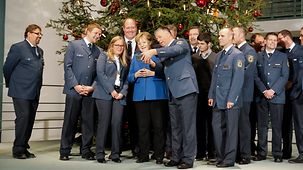 Chancellor Angela Merkel is presented with the Christmas trees at the Federal Chancellery.