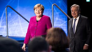 Chancellor Angela Merkel walks beside António  Guterres, United Nations Secretary-General.
