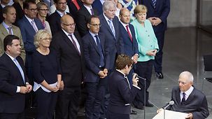 In the German Bundestag Annegret Kramp-Karrenbauer is officially sworn in by Bundestag President Wolfgang Schäuble. Beside her stand the Chancellor and all Cabinet ministers.