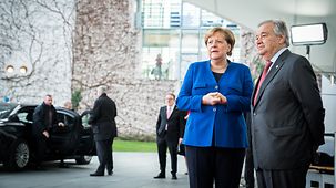 Chancellor Angela Merkel stands next to Antonio Guterres, United Nations Secretary-General.