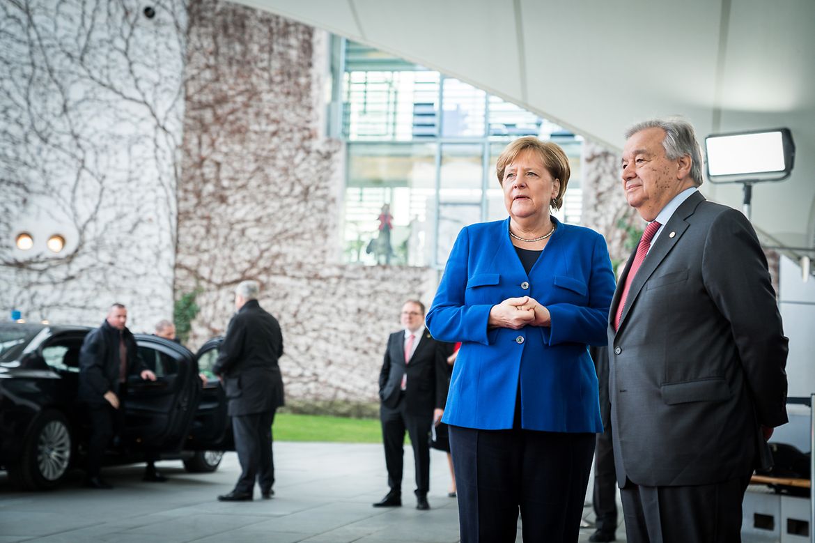 Chancellor Angela Merkel stands next to Antonio Guterres, United Nations Secretary-General.