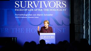 Chancellor Angela Merkel speaks at the opening of the "Survivors" exhibition.