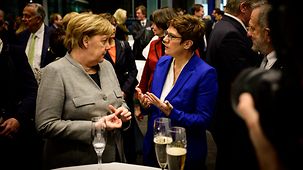 Chancellor Angela Merkel in conversation with Annegret Kramp-Karrenbauer, Federal Defence Minister, at an event to celebrate the 50th anniversary of the CDU Lower Saxony state group in the German Bundestag