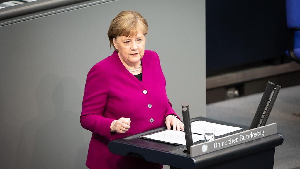 Kanzlerin Angela Merkel steht am Rednerpult des Deutschen Bundestags.