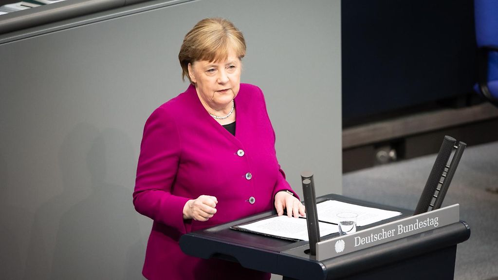 Chancellor Angela Merkel at the lectern in the German Bundestag